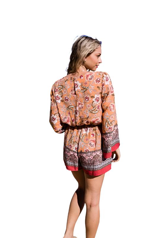 Create a look that stands out with this BOHO Bunch floral Print romper. This imported item offers a Long Sleeve Surplice Print with an elastic waistband for an adjustable fit. Available in sizes S, M, and L.