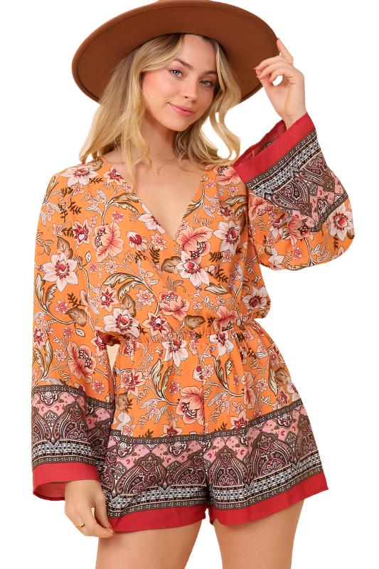 Create a look that stands out with this BOHO Bunch floral Print romper. This imported item offers a Long Sleeve Surplice Print with an elastic waistband for an adjustable fit. Available in sizes S, M, and L.