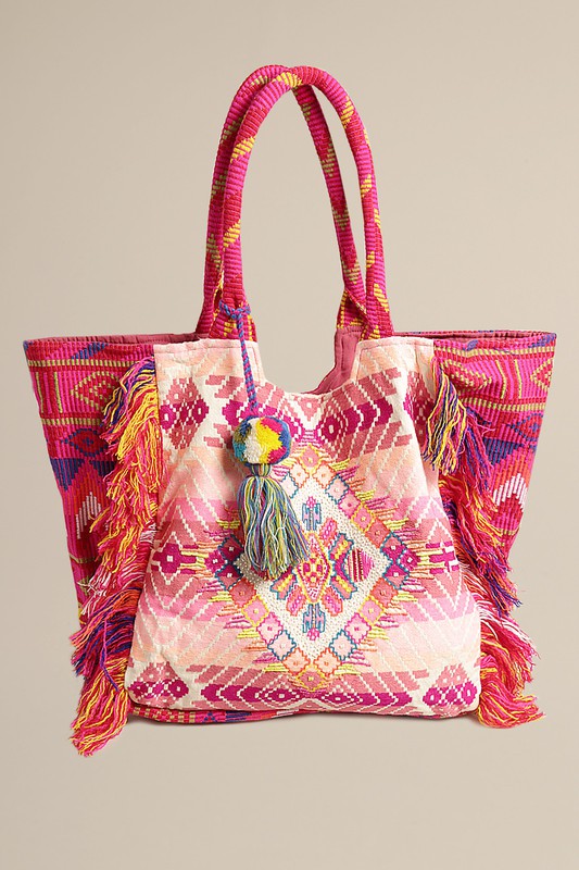 Embrace the free-spirited charm of the Bohemian Bliss Tote Bag.  This bohemian boho bag features intricate fringe and tassel details that add a touch of whimsy and elegance to your look. 