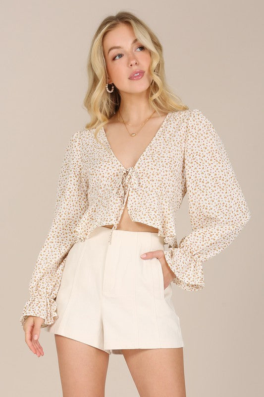 This Flora Floral Frill Blouse is the perfect addition to your wardrobe. Featuring a stylish floral pattern, a flattering V neck and puff sleeves. Crafted from a non-stretch material, it is not lined but not very sheer. To ensure its quality and longevity, machine wash cold and tumble dry low. Model is 5' 6" and wearing size Small; length is approx 17" in size Small.